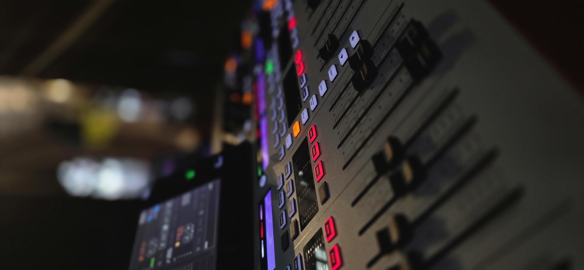 Mixing console faders on an installed audio system